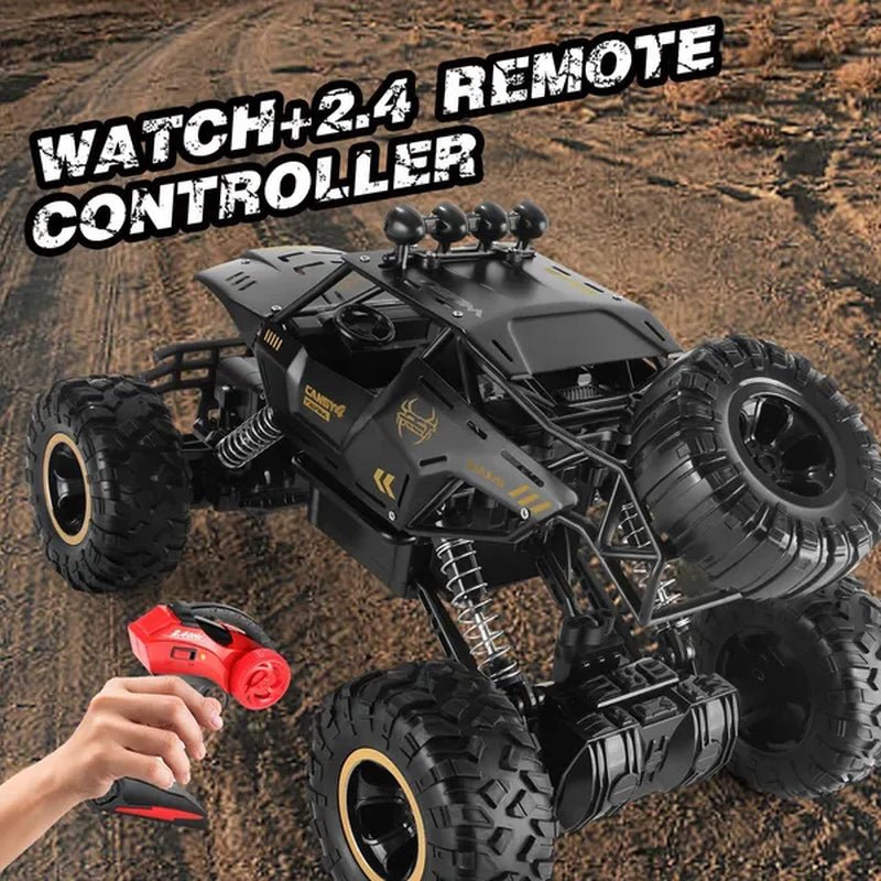 Hand holding 2.4GHz remote controller with black RC monster truck on dirt trail in background