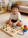 Boy playing with Montessori Wooden LED Busy Board light-up switches