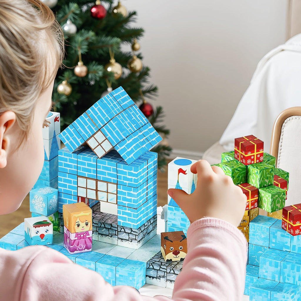 Young girl building a glacier castle with magnetic blocks near a Christmas tree