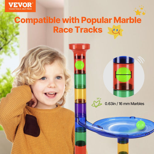 Child smiling beside marble run track showing 16mm marble compatibility with colorful stacked block towers