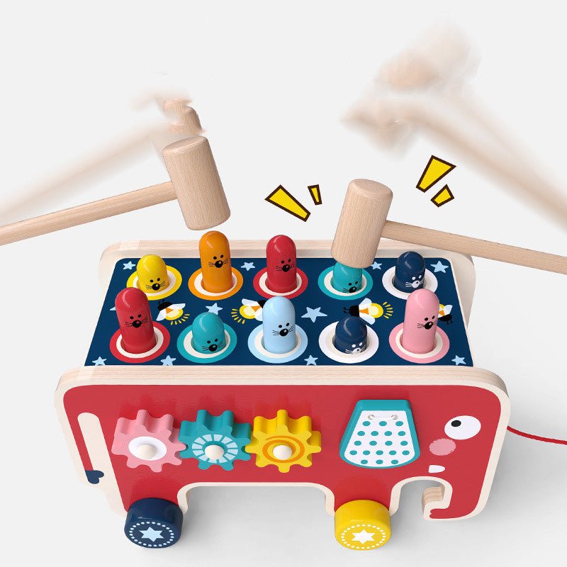 Two wooden mallets pounding colorful animal pegs on Montessori elephant pounding bench toy