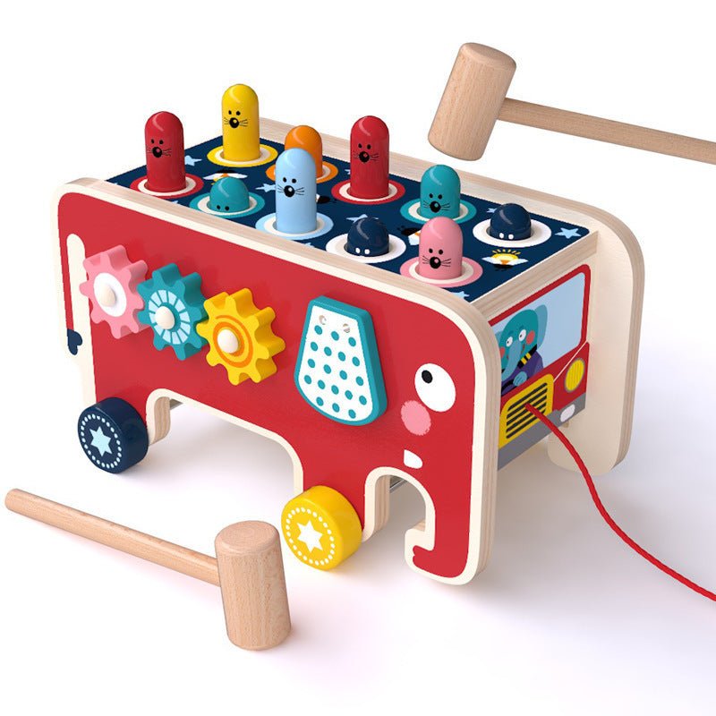 Red elephant wooden pounding bench toy with colorful pegs, gear spinners and two wooden mallets on white background